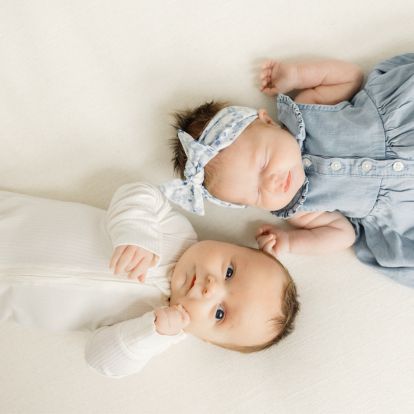 two young babies laying side by side