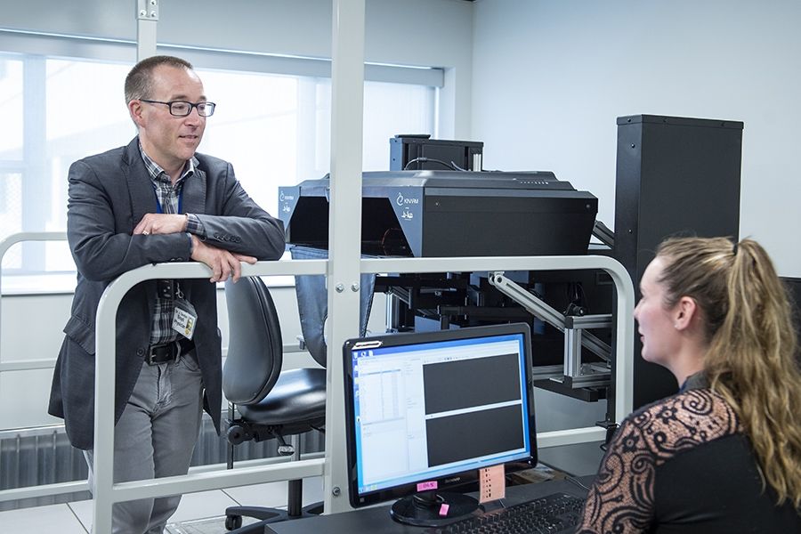 Dr. Gord Boyd and PhD candidate Jessica Vanderlinden with the KINARM in the W.J. Henderson Centre for Patient Oriented Research.