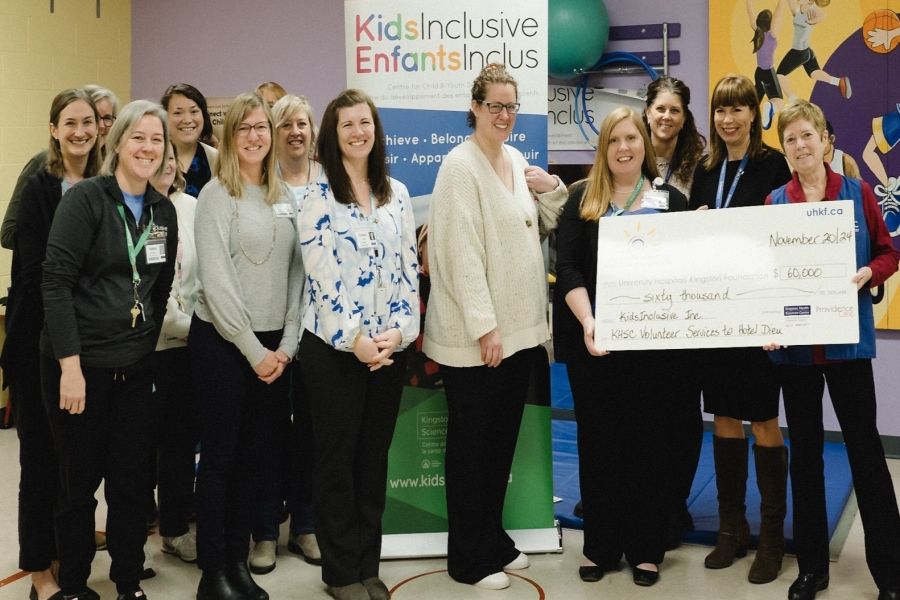 KHSC Volunteer Services to the Hotel Dieu Hospital (HDH) site present a cheque to the KidsInclusive team.