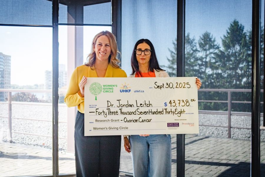 KHSC anesthesiologist Dr. Jordan Leitch (left) receives the donation from Rachel Koven, chair of the Women’s Giving Circle (right).