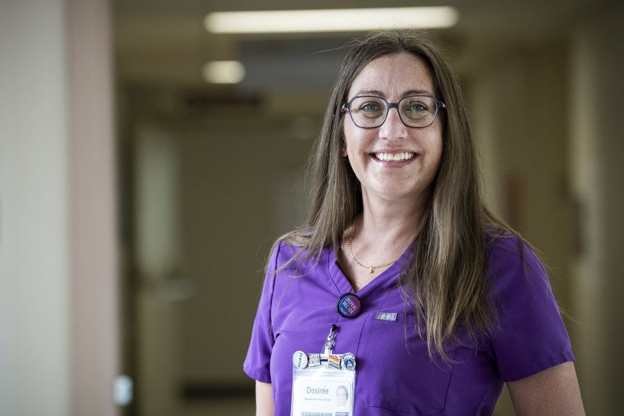 Desirée vandenTillaart is photographed standing in a hallway at the Kingston Bariatric Centre of Excellence, located at the Hotel Dieu Hospital site. She has straight, medium brown hair that goes past her shoulders. She has blue eyes, wears glasses and is wearing purple scrubs.