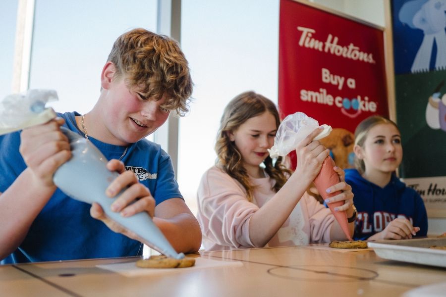 Student volunteers decorate Smile Cookies at the campaign kick-off event