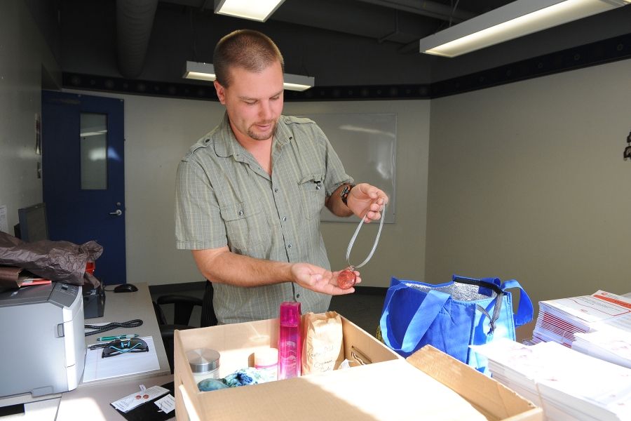 Chris Hammer, KGH Employee Campaign Coordinator, organizing donated items for the Early Bird gift basket draw.
