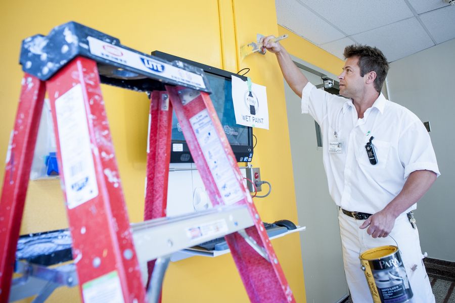 Painter Raymond Houle puts the final touches on a wall near the 'Tuck Shop' bearing the colour of the Connell wing.