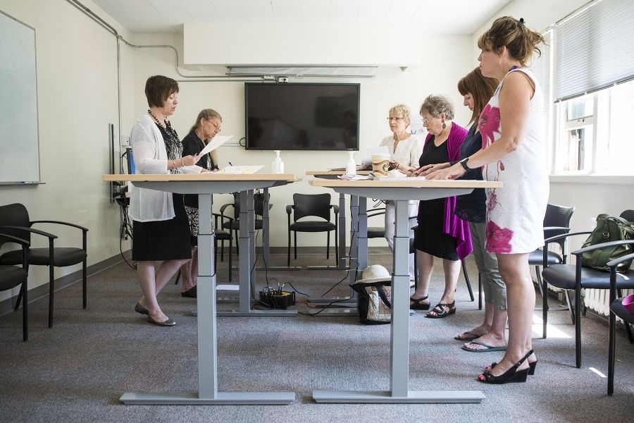 The Dietary 2 conference room is the scene of a new style of meeting where chairs are pushed aside.