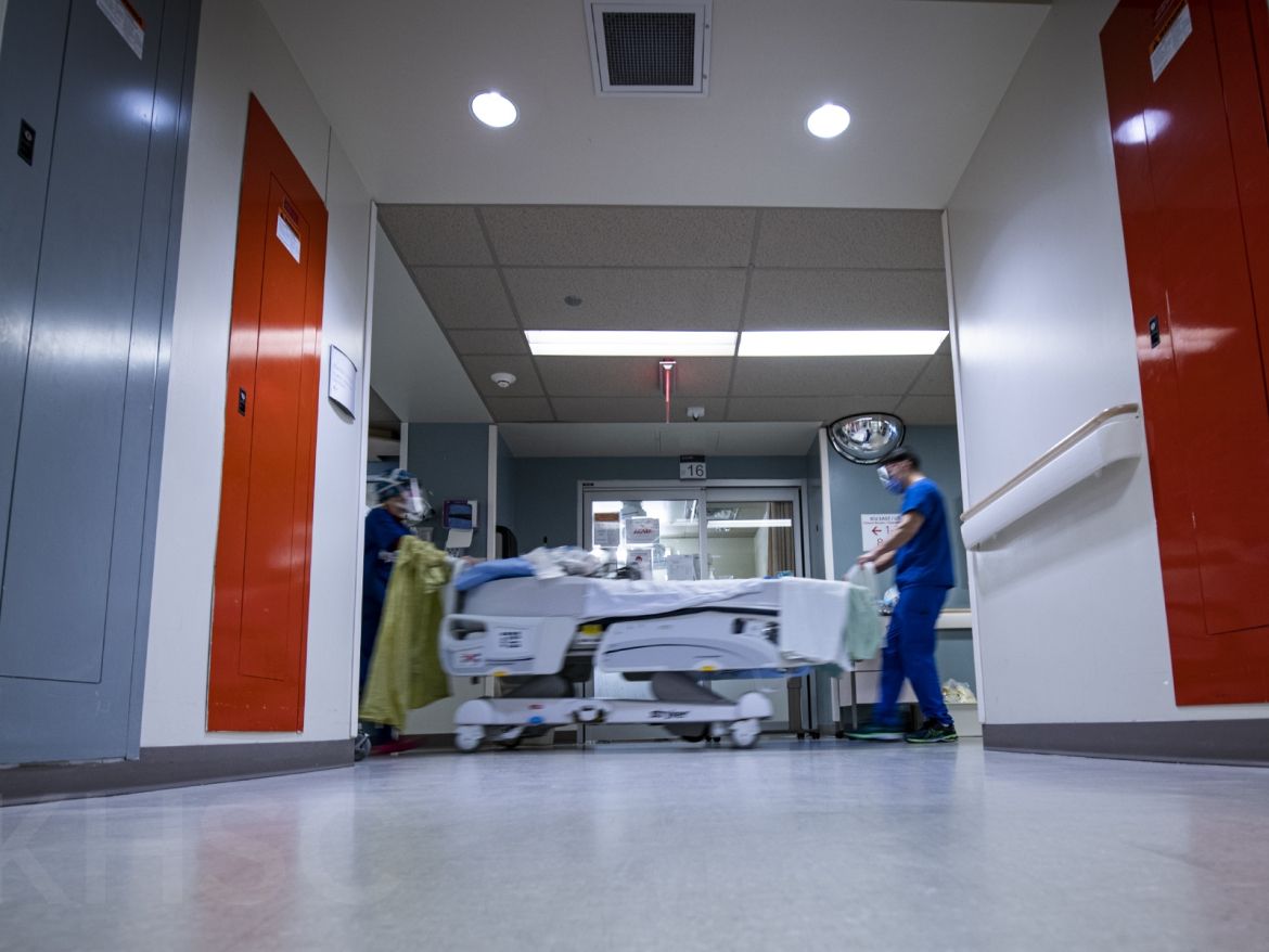 staff moving bed around ICU