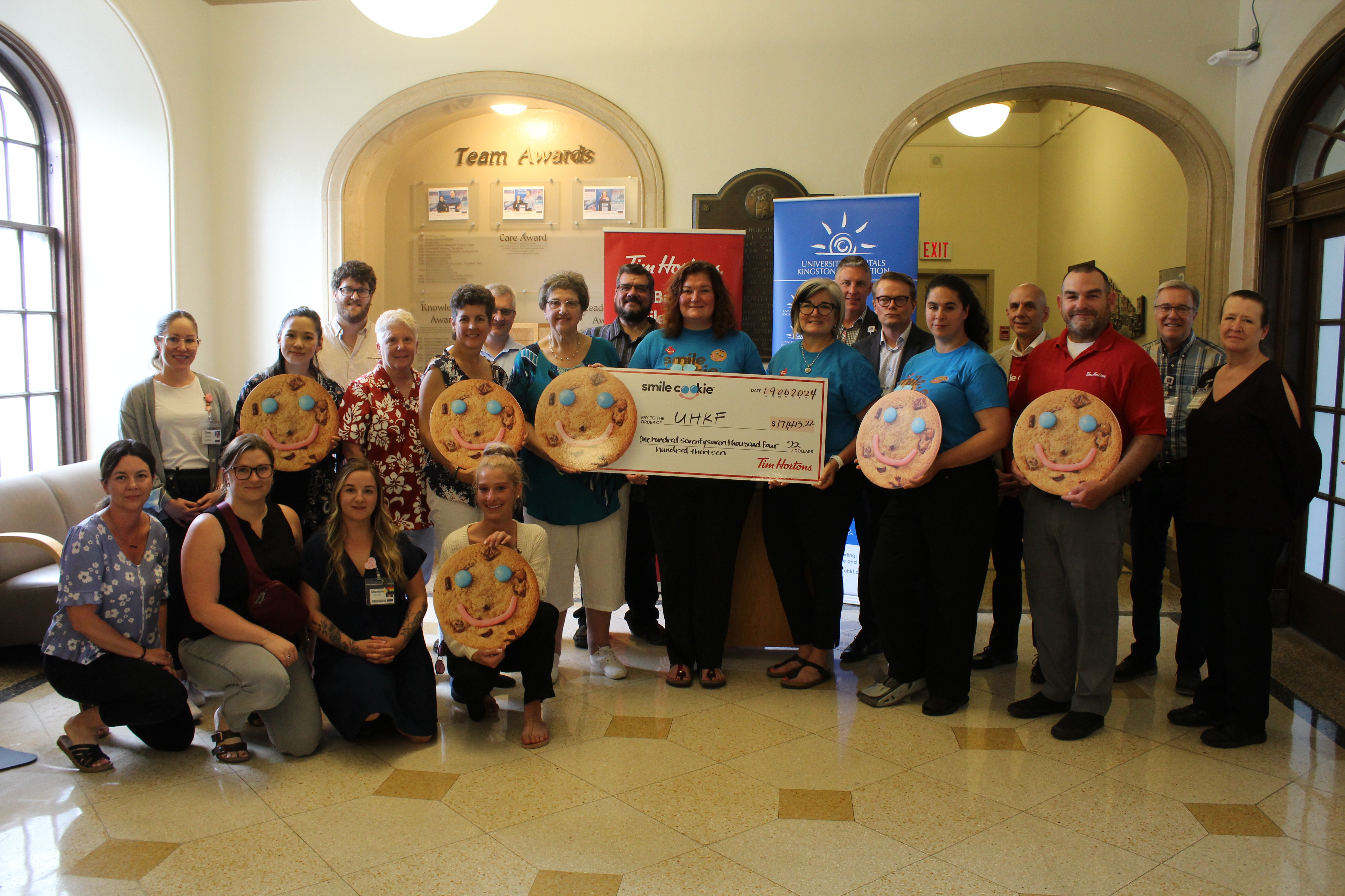 Representatives from Tim Hortons present a cheque to staff from KHSC and the UHKF